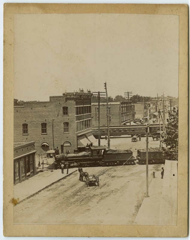S. Elm St. railroad crossings, ca. 1900. Building slightly left of center is the Cascade Saloon.