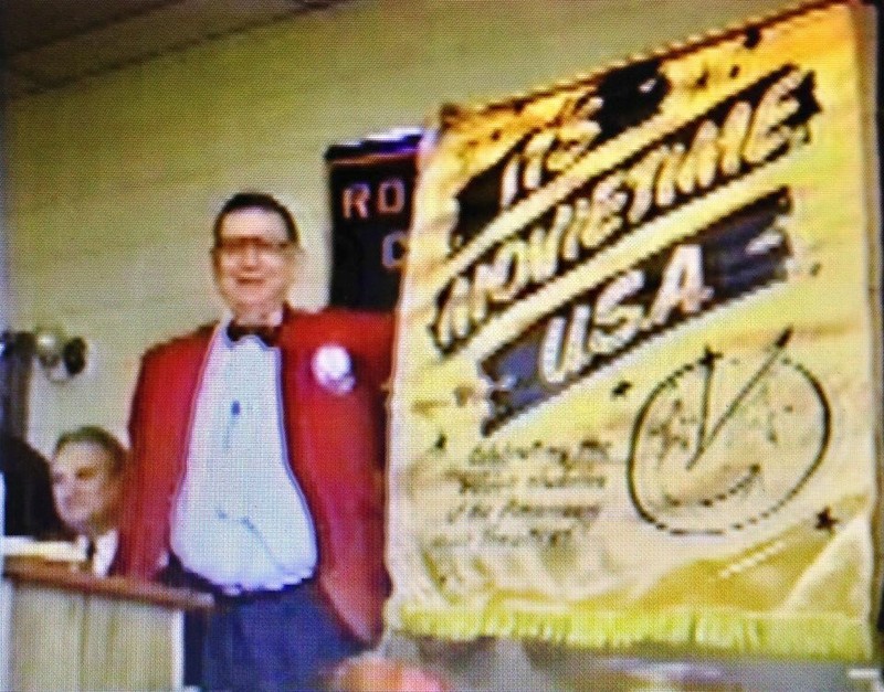 Mr. W.P. Florence, Jr. in the 90's giving a presentation with his 1950s satin "It's Movie Time USA" banner about the history of theaters in Magnolia. This banner was used at the Cameo Theatre and is still owned by the Florence Heritage Foundation.