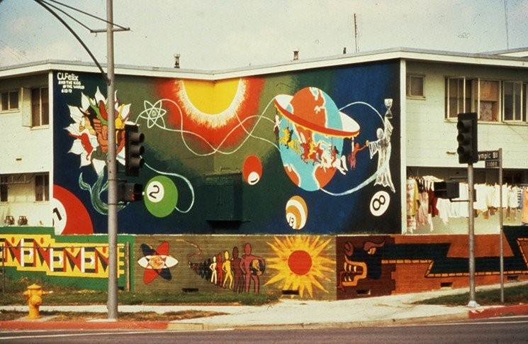 Estrada Courts' mural "Give Me Life" painted by Charles "Cat" Felix and the Children of the World.