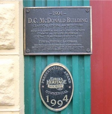 Historical marker mounted on pilaster, left side of entryway 