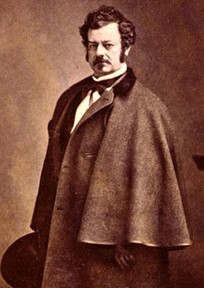 Sepia-toned portrait of Edwin Forrest in three-quarter view, wearing a cape coat and holding a hat.