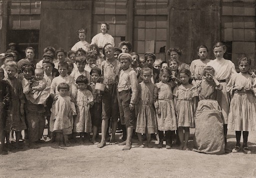 A group of mill children gather outside on their break.