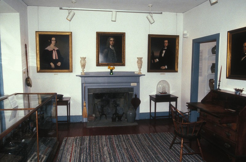 Paintings and other items are on display inside.