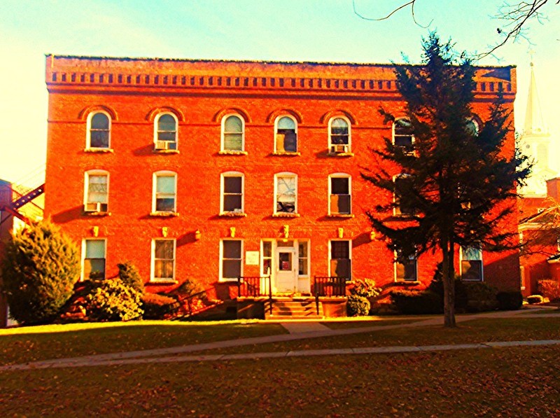 Notice that even though it is a simple building, there are some unique features. For example: the first floor windows are rectangles - second floor windows have half arches - and third floor windows have full arches.