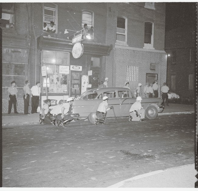 Police taking cover during the riots 