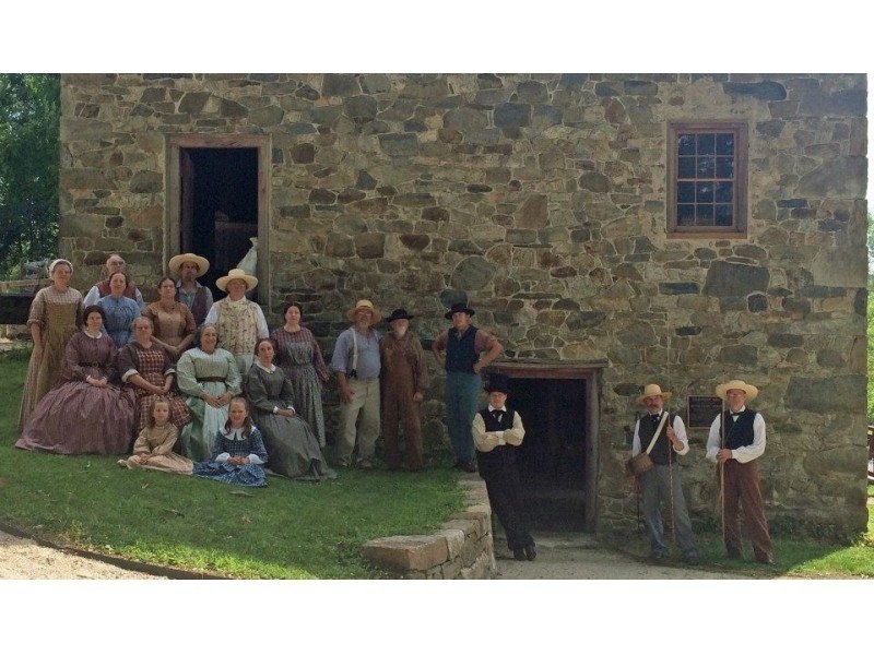 Period actors pose near the mill during one of their educational programs. 