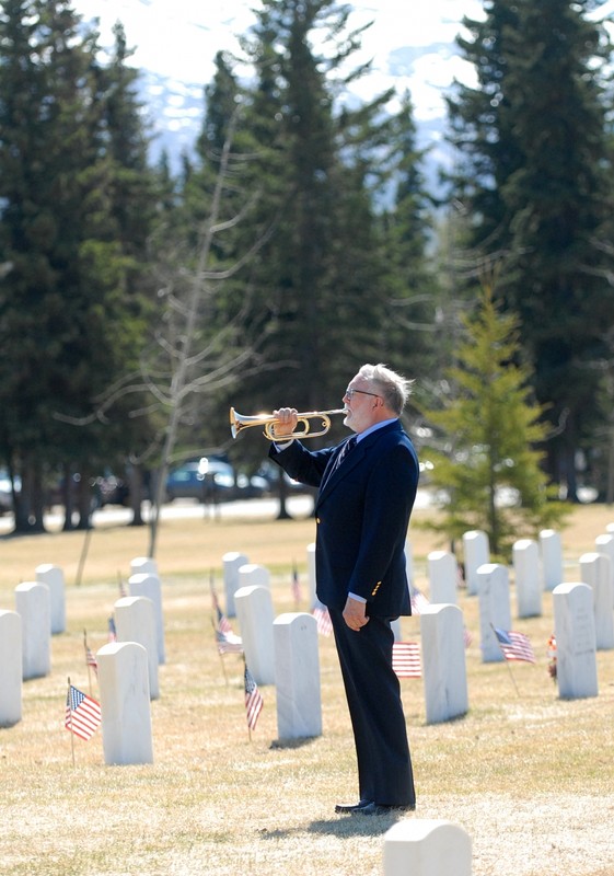 A bugler playing at a Memorial Day Ceremony at Fort Richardson National Cemetery