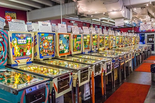This is picture 1 of 5, credited to photographer Joseph Murphy, that shows what type of pinball games would be at Silverball Museum Arcade. The games "Majorettes" and "World Fair" can be seen side by side.