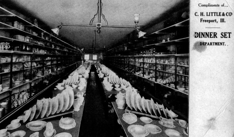 A sales postcard. At left is a large black and white photo of a narrow, deep room, filled with displays of fine china. At upper right are the words "Compliments of C.H. Little and Co., Dinner Set Department".