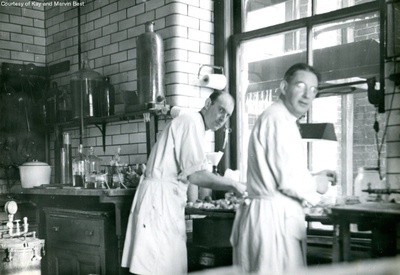 Tony Delahant, right, at work in with fellow laboratory technician, Robert Liddy, on left (c. post-1934)