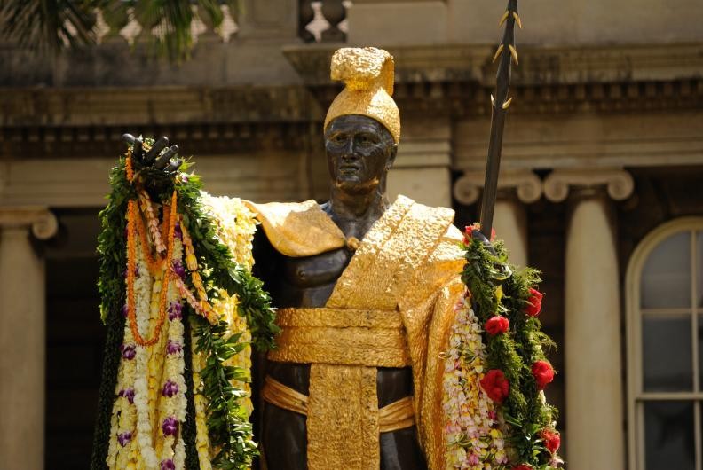 This is the second statue located in front of the Iolani Palace in Honolulu. This photo is taken after the Hawaiian people have placed lei onto the statue to celebrate the June 11 holiday. 