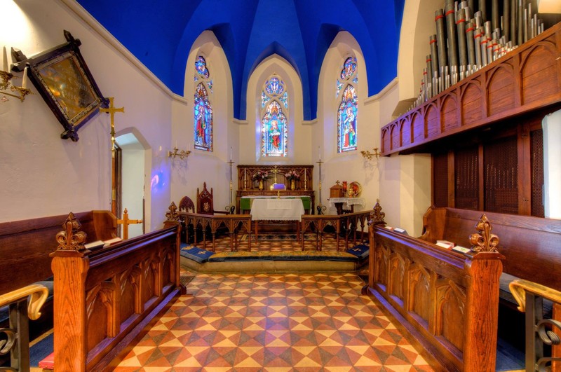 These three stained-glass windows above the alter represent faith, hope and charity. 