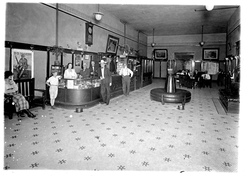 Photo of the lobby of the Wenatchee Hotel, persons unidentified.  The hotel operated from 1910 - 1965.