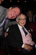 James M Nederlander and his son, Jimmy Nederlander smile for a picture while watching one of the shows in their theatre. 