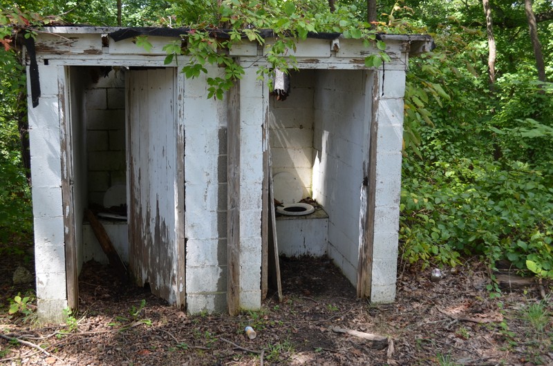 The structure includes several original buildings, such as these outhouses