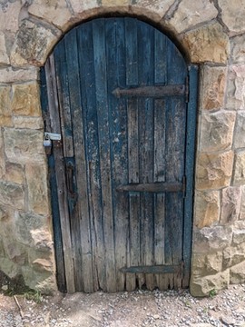 Close-up of pumphouse door with iron elements visible