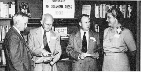 (left to right) Van Endicott, superintendent of the University Press; Will Ransom, art editor; Savoie Lottinville, director of the Press; and Mary Stith, assistant editor at openhouse of new press building in 1948.