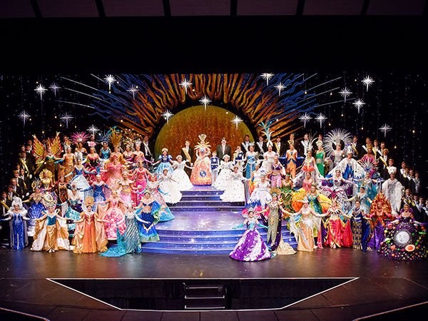 This image depicts the ending of The Coronation of the Queen from a recent Rose Festival.  As you can see the women are all wearing exotic dresses and are each escorted by a male escort.