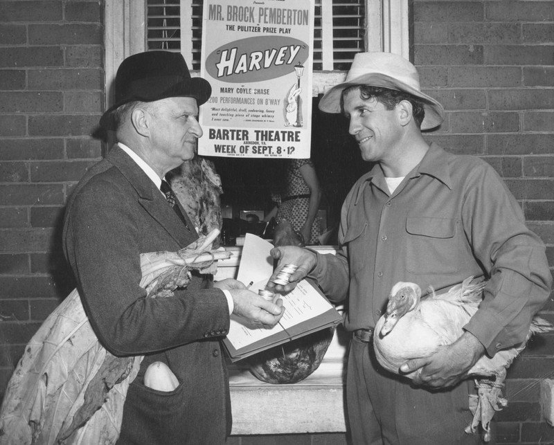 Robert Porterfield and a theatre patron demonstrating a bartering exchange.