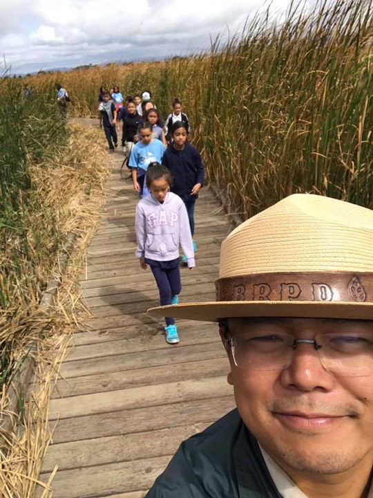 A Park ranger leads a field trip through the marsh boardwalks. Seasonal rainfall can cause the boardwalks to close intermittently (Coyote Hills Facebook).