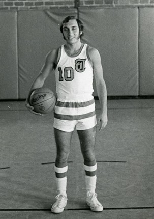 Photo of a student on the basketball team in the old gymnasium