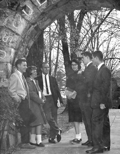 Students gather under the arch.