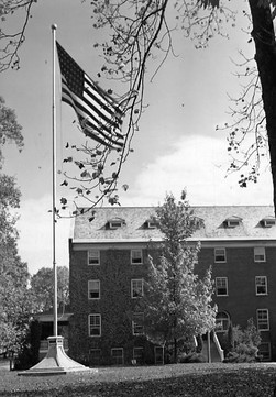 The flag pole with Virginia Hall in the background.