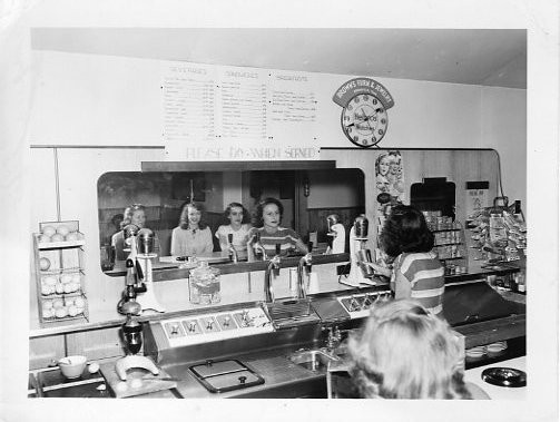 Students ordering food in old student union building. 