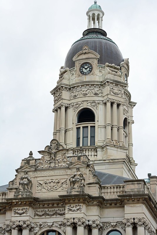 The tower has two levels and features four clocks and a large bell.