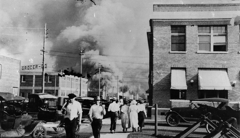 A street in Tulsa with smoke in the distance after the riot.