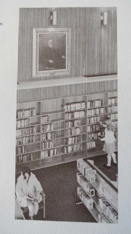 Child choosing book in library