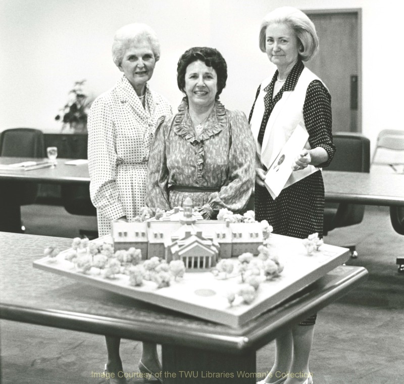 Margaret Estes Davis, Chair of the TWU Board of Regents; Dr. Evelyn Huey, seventh President of TWU (center); and Betty Carpenter, Vice Chair of the Board stand with a model of the Blagg-Huey Library. (Photo: 1980s Courtesy TWU Woman's Collection)