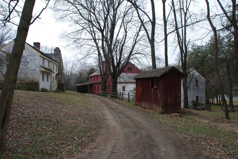 View from historic area with corn crib in foreground and grist mill in background