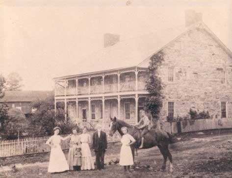 This photo was taken around the later 1800s to the early 1900s.  The women are wearing dresses from that time period while the young boy is riding a horse.  Courtesy of the Jean Bonnet Tavern Website