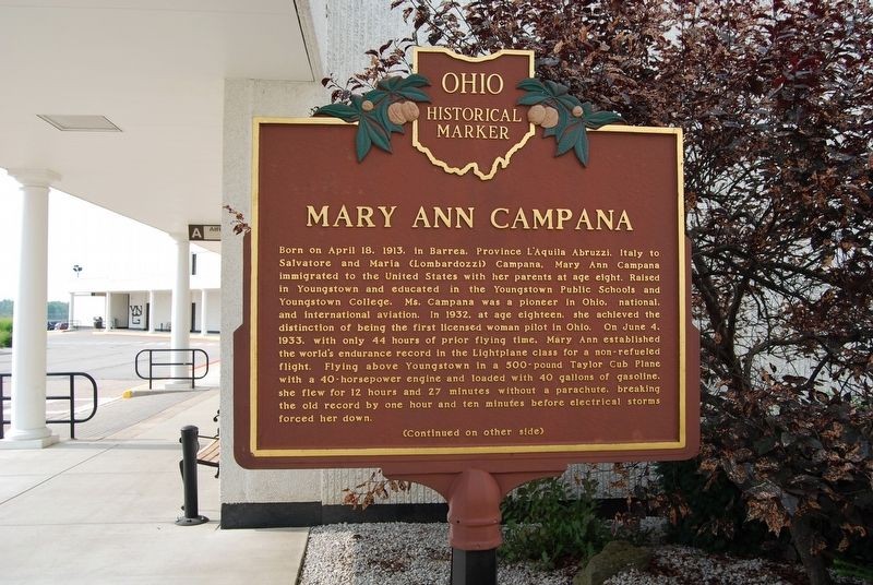 The marker is located at the entrance to the airport and was dedicated in 1993.