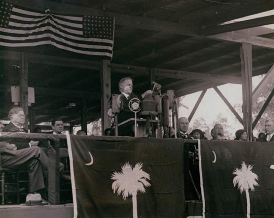 Picture of President Hoover standing on the speakers' stand to deliver his speech. 