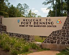 The welcoming sign to Fort Benning in Columbus, Georgia. The sign states how Fort Benning is home of the Maneuver Center of Excellence. 