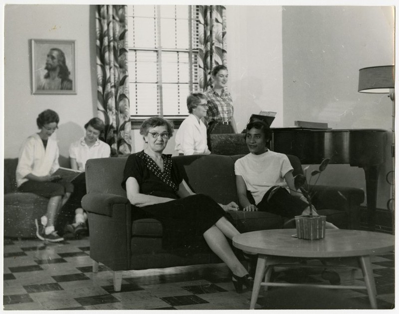 Larimore students enjoying some downtime in the commons area with dormitory house-mother. Photo courtesy of Elwyn B. Robinson Department of Special Collections, University of North Dakota. UAP28928. 