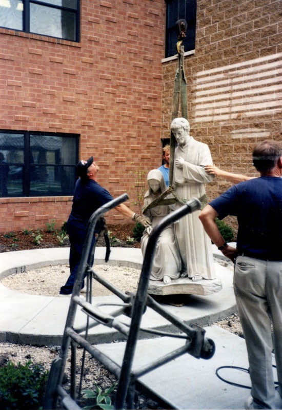 Workers install statuary at Nazareth Court and Center, 1998.