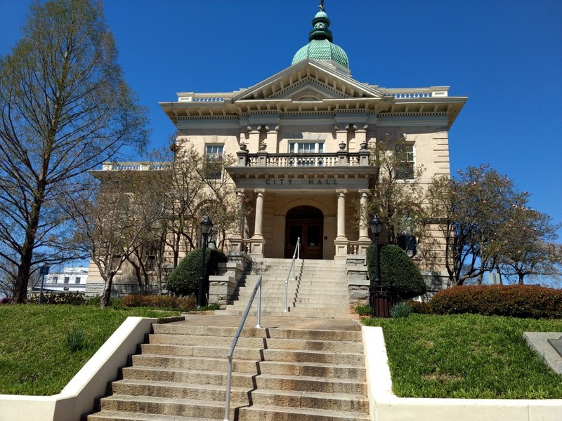 A view of both the City Hall staircase and the iconic weather-vane and bell tower.