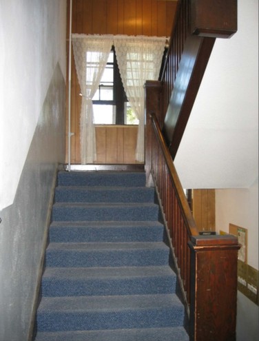 The stairs inside showing a view of the original woodwork. 