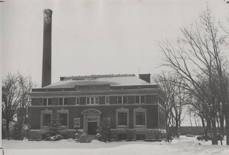 The Carnegie Building in 1948 with the smoke stack of the Steam Plant visible in the background.