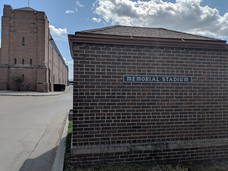 The original ticket booth with a sign that reads "Memorial Stadium."