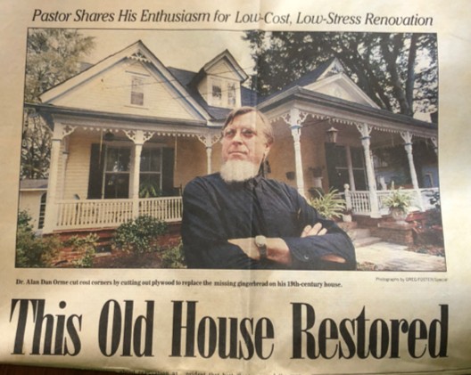 Dr. Orme posing with his house. 