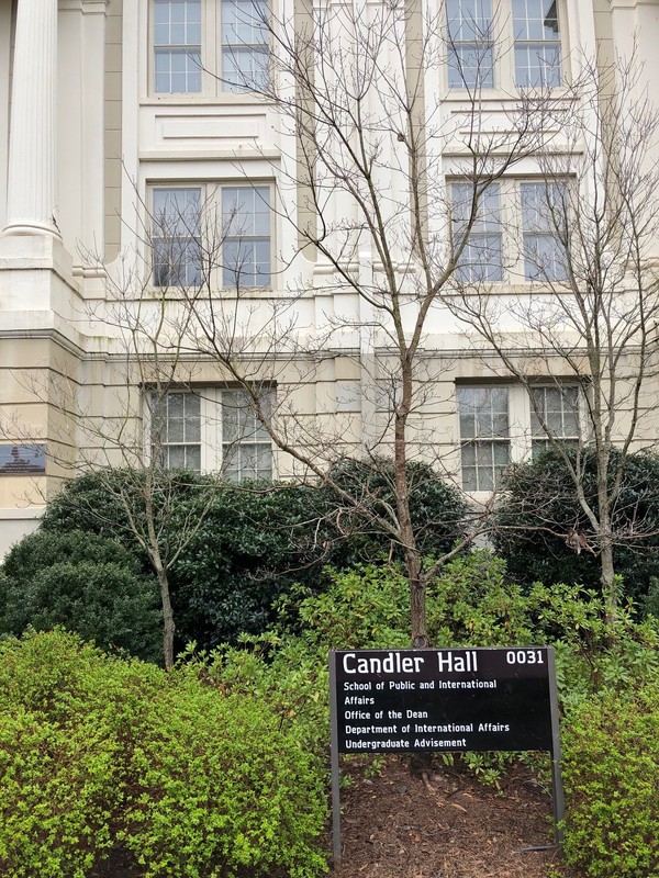 UGA Building Marker outside Candler Hall, reading: "Candler Hall, 0031, School of Public and International Affairs, Office of the Dean, Department of International Affairs, Undergraduate Advisement"