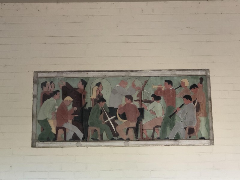 Smaller mural over building's side entrance located east of the main entrance.