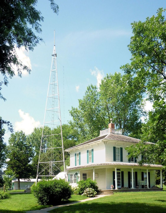 The Ensor Farmhouse with one of two radio towers