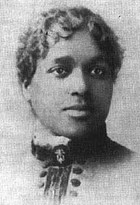 Black and white protrait of a woman with close-cropped curly hair