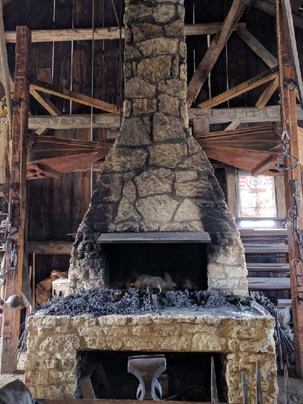 Our forge has two firepots built into the bottom section to allow four people to work at the same time. Notice the bellows on both sides of the forge, one from Lisle's former Haumesser shop (right) and one donated by the Aurora Historical Society (left)...