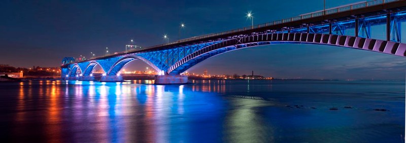 Photograph of the bridge at night from the Peace Bridge's official website